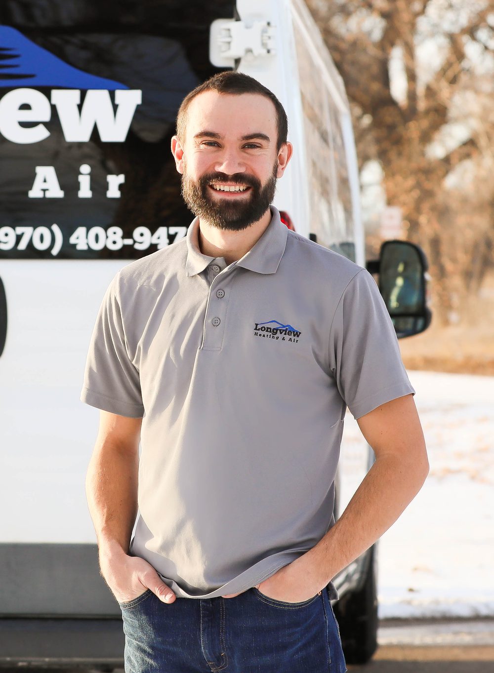 Owner of Longview Heating & Air in front of a company service van